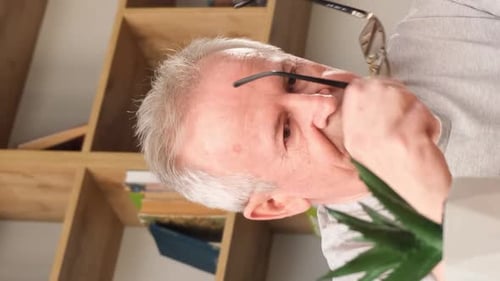 Senior Man Rubbing Eyes at Home, Portrait