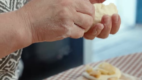 Baker Preparing Apple Dough in a Sunlit Kitchen