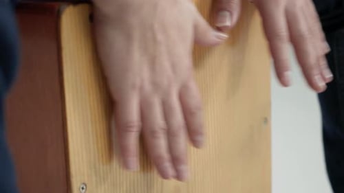 Playing a Wooden Cajon Drum