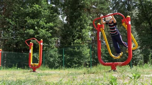 Child Boy Engaged on Sports Training Simulator at the Street