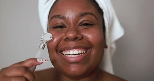 Woman Uses Facial Roller for Skincare Routine