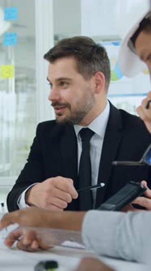 Business Meeting Discussion with Architect at Office Workplace