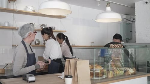 Entrepreneur and team are working at bakery and coffee shop.