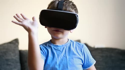 Boy Experiencing Virtual Reality with Headset Indoors