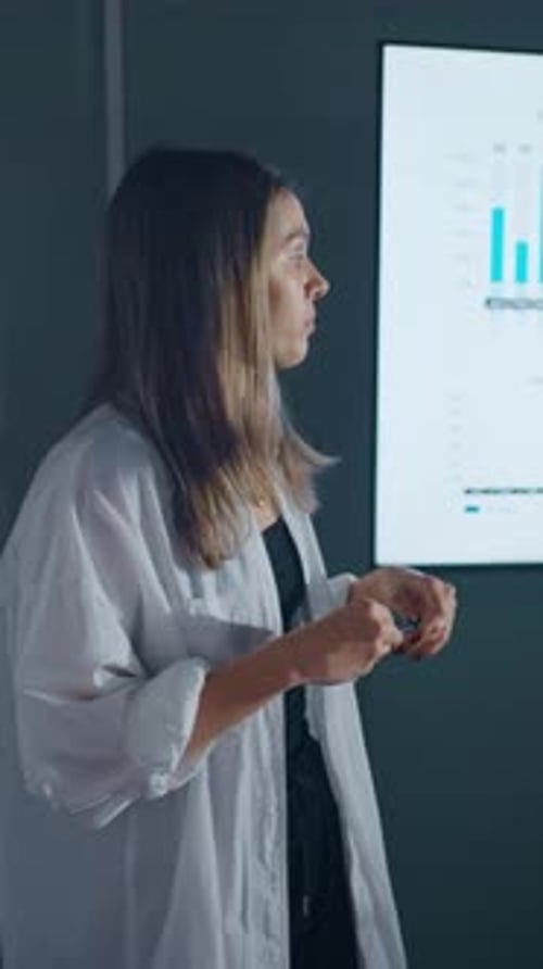 Confident Woman Giving Business Presentation to Colleagues