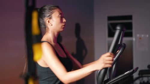 Woman Working Out at the Gym on Equipment