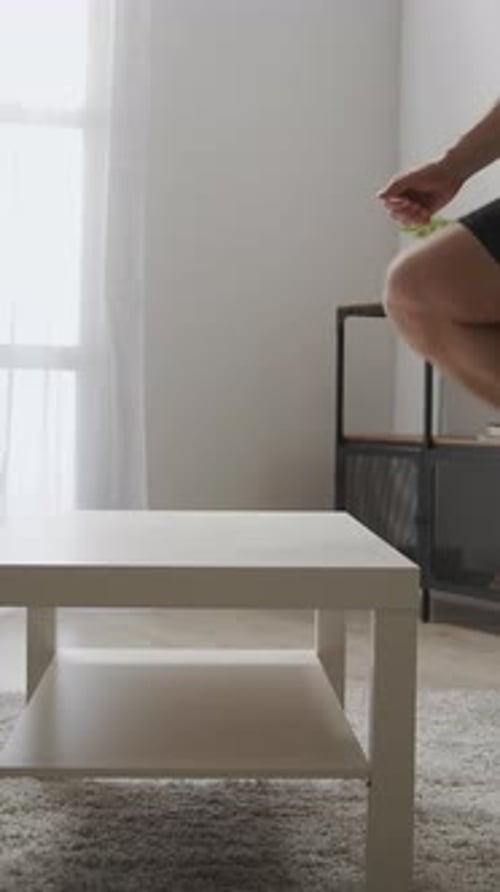 Adult Man Doing Step Aerobics on Table Indoors