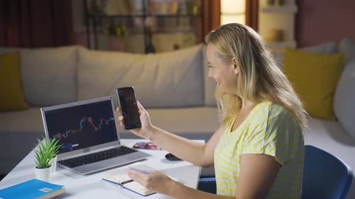 The woman who monitors the stock market makes purchases with a credit card.