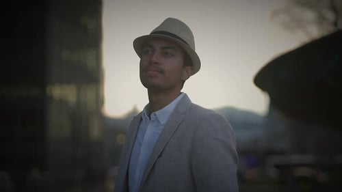 Fashionable Young Handsome Man Wearing a Hat and Casual Clothes in the City