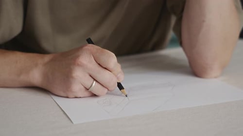 Mindful Practice Man Sketching Geometric Figure on White Paper
