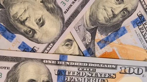 One hundred dollar bills rotate close up macro view. Cash USD money background. 100 dollars US