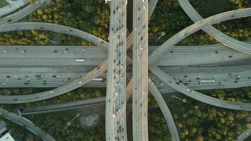 Aerial Drone View of Busy Highway Overpass and City Traffic