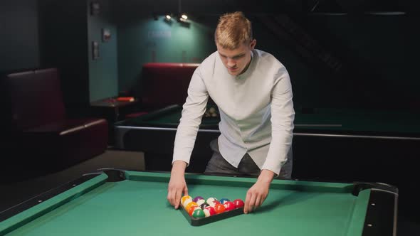 Sportsman Arranging Billiard Balls in Triangle Formation on Green Pool ...