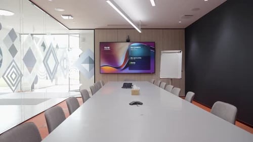 Slow establishing shot of a large empty conference table ready for a meeting