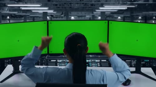 Happy Woman Celebrating While Working With Mock Up Multiple Computer Monitor In Data Center