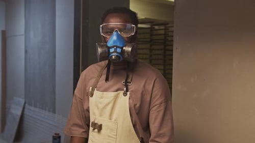 Portrait of Black Man in Respirator Mask and Goggles in Woodworking Workshop