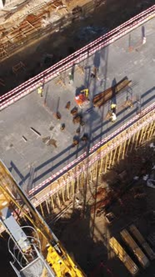 Vertical Video of Construction Workers in the Roof of New Building