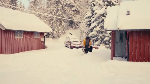 Man With Alaskan Malamute Dog Pet In Countryside Village During Winter. Static Shot