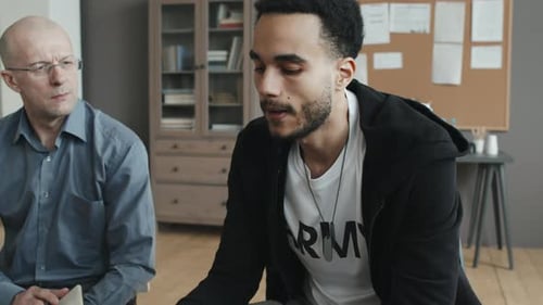 Man Shares Difficult Feelings in a Group Therapy Session