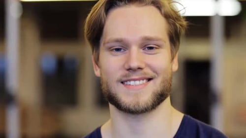 Smiling young man with blonde hair and beard