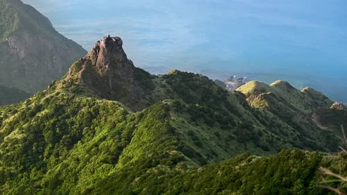 Standing on the ridge overlooking the village and the sea in the distance.