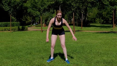 Lovely Athletic Fit Middle Aged Woman Practicing Skater Lunges Exercise in Park