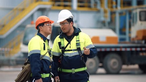 Asian Male Supervisor and Builder in Construction Protective Uniform Discuss Job Manufacturing Plant