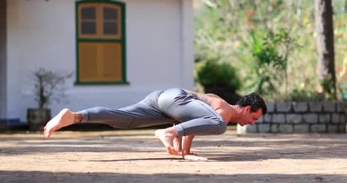 Man training Bakasana Yoga asana outdoors3