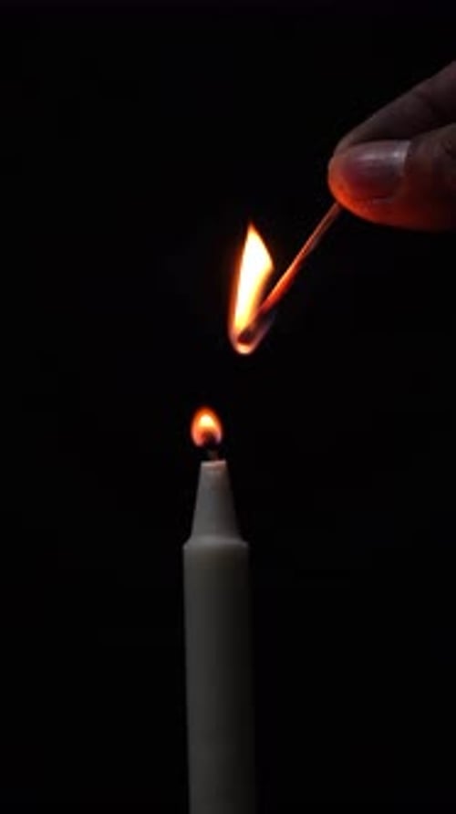Candle Being Lit in the Dark