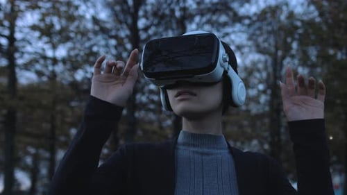 Asian female Using Virtual Reality in park