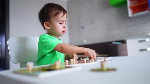 Young Child Playing Board Game at Home