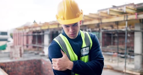 Construction, contractor and man with shoulder pain, accident and injury at building site