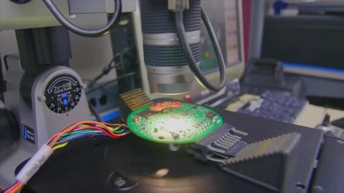 Microchip being inspected under a microscope