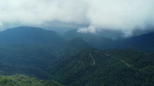 Aerial view of sea of fog on tropical mountains in the early morning. Layers of mountains