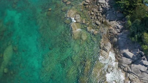 Top Down Seashore Waves Crashing on Rock Cliff Beautiful Sea Surface in Sunny Day Summer Background