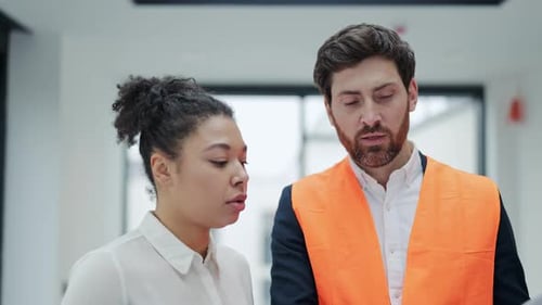 Investor and Architect Discuss Blueprint in Office During Business Meeting