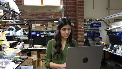 Woman Using Laptop in Technology Workplace