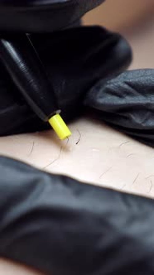 Hair Removal Process with Red Tweezers and Wax Applicator