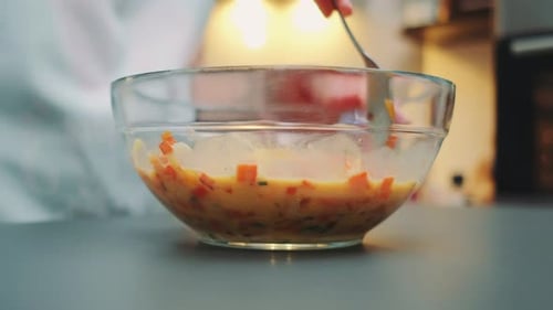 Mixing Eggs and Vegetables in Glass Bowl