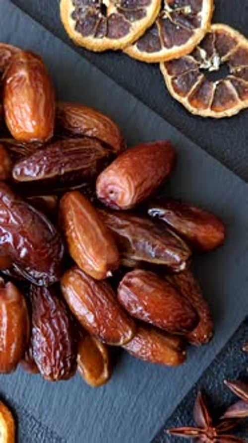 Dried dates on a ceramic plate for Ramadan or Iftar. Dates fruit as a background