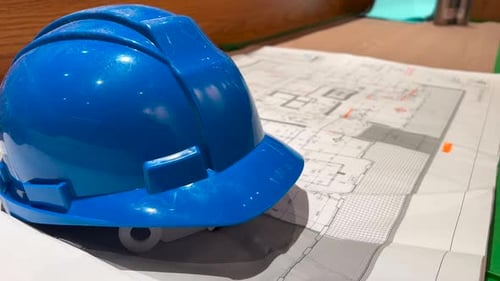 Construction industry - hard hat and building plans