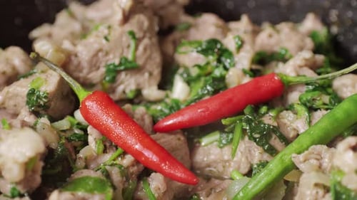 Chicken or Pork Stew with Red and Green Pepper Onion and Spices Cooking in a Frying Pan Traditional