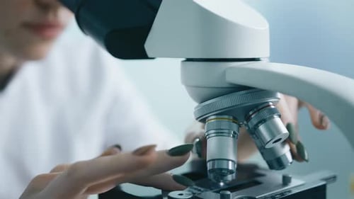Close Up Female Researcher Scientist Looking at Samples Under Microscope Slow Mo