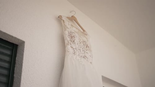 Wedding Dress Hanging in Room, Bridal Preparation