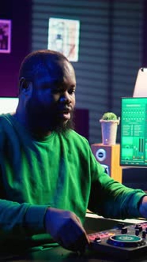 Young Adult Using Mixing Board in Studio