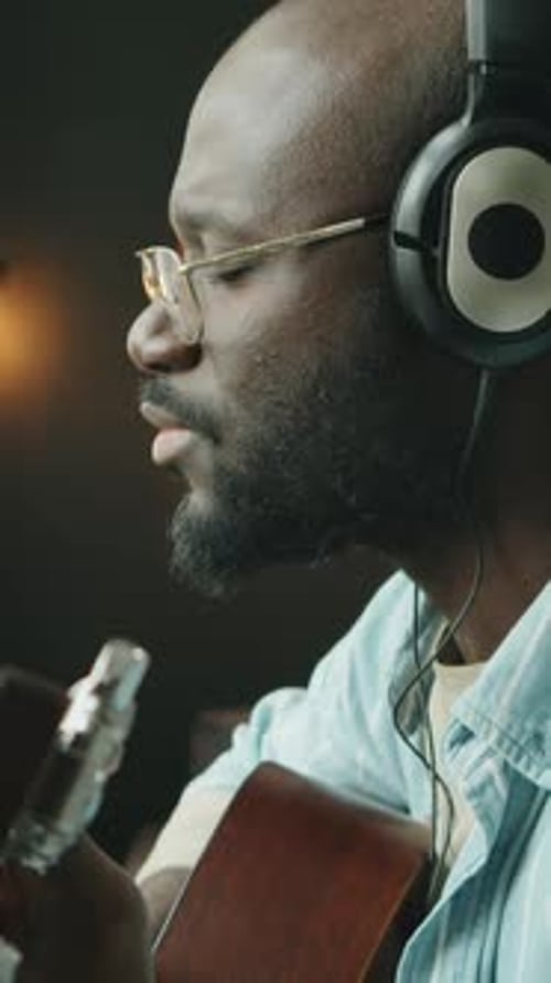 African American Musician Producing Song in Home Studio