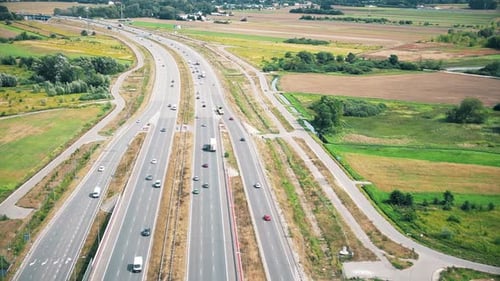 Urban veins: Drone footage over highway interlaced, reflecting non-stop flow of city traffic. Vehicu