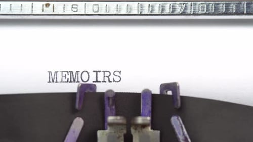 Memoirs word closeup being typing and centered on a sheet of paper on old vintage typewriter mech