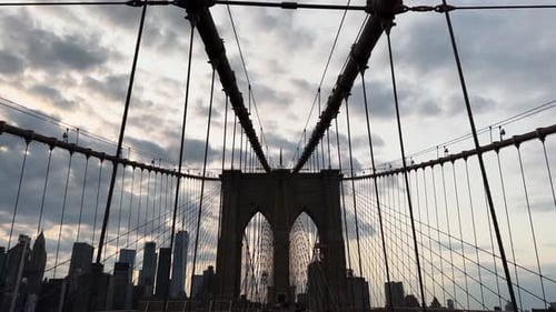 Sunset walk on Brooklyn Bridge in New York City, United States