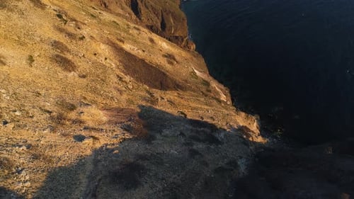 Golden Cliffs Meeting Deep Blue Ocean at Sunset